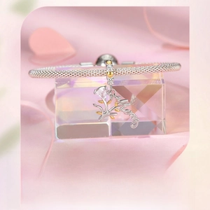 Detailed macro view of Mom tree pendant with gold leaves and cubic zirconia on a silver bracelet