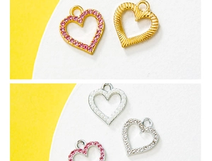 Detailed macro view of heart-shaped zinc alloy charms with pink crystals and pearls