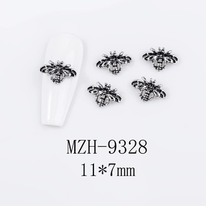 Detail of 11x7mm vintage silver bee nail art charm with intricate engraved wings texture