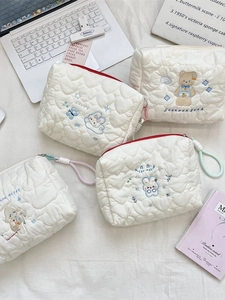 Set of four white quilted cartoon makeup bags with bear and rabbit embroidery