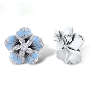 Macro detail of blue enamel daisy stud earrings with silver plating and cubic zirconia