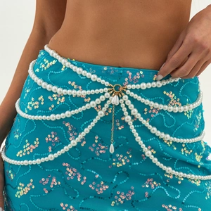 Detail showing multilayer pearl body chain with gold metal rings and drop pendants