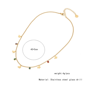 Detailed view of golden stainless steel necklace with butterfly and glass drill pendant