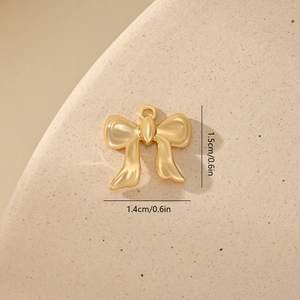 Detailed macro view showing a 1.5cm gold bow pendant charm with size measurements