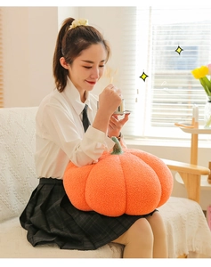 Cozy pumpkin plush pillow shown in a modern living room setting for home decor
