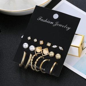 Detailed view of 9 pairs golden geometric earring set with pearls and rhinestones