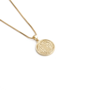 Detailed view of Saint Benedict coin pendant in gold plating with Latin engraving
