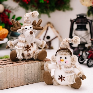 Close-up of knitted Christmas plush reindeer and snowman ornaments with snowflake patterns