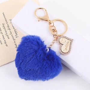 Detail of blue plush heart keychain with gold hardware and sparkling I love you charm