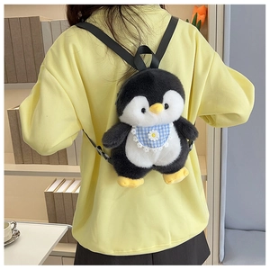 Rear view of a cute plush penguin backpack with a blue plaid bib on a girl