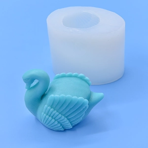 Swan silicone mold for DIY baking with detailed white mold and blue finished swan product