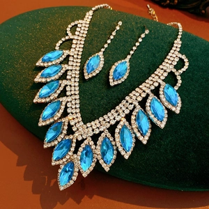 Detailed macro view of blue gemstone jewelry set featuring a V-shaped necklace and teardrop earrings