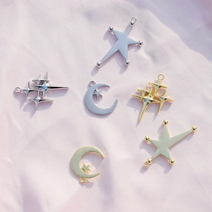 Flat lay of gold and silver alloy celestial star and moon charms for DIY jewelry making