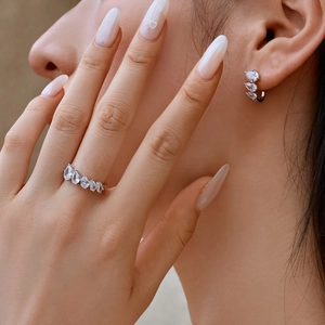 Detail of S925 sterling silver ear studs featuring irregular water drop zircon settings