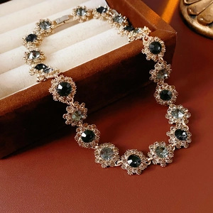 Detail of vintage flower necklace with dark crystals in a velvet jewelry box