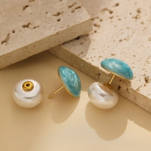 Elegant gold-tone stud earrings with blue marble enamel finish and large white pearls