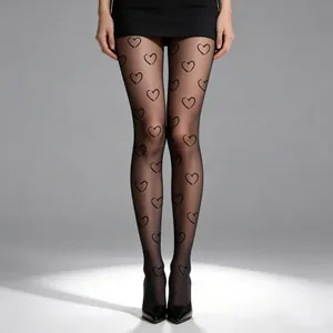 Detailed view of sheer black tights featuring elegant heart patterns and durable fabric