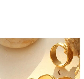 Close-up of gold double-layer snake chain necklaces with textured geometric patterns