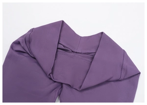 Close-up of high-waist purple seamless yoga pants featuring elastic ribbed waistband
