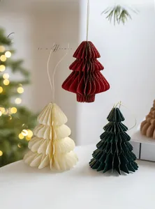 Detailed close-up of honeycomb paper Christmas tree ornaments with gold gilded edges