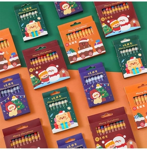 Close-up of festive Christmas crayon box sets featuring 8 and 12 colors with cute holiday art
