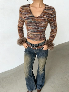 Slim-fit V-neck striped top for women featuring plush faux fur cuffs and denim pants