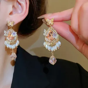Vintage gold butterfly earrings with pink crystal drop and sparkling rhinestones