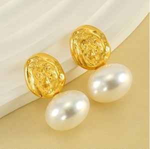 Detailed macro view of French vintage gold textured studs with large white drop pearls
