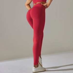 Detail of red high-waisted yoga pants showing seamless knit fabric and push-up butt lifting effect