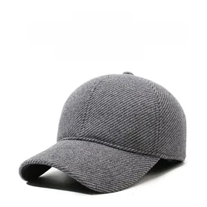 Detailed macro view of gray winter baseball cap with thick wool fabric and side metal logo