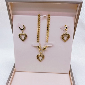 Golden heart wing pendant necklace and earrings set presented in an elegant gift box