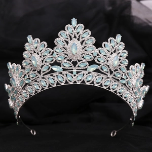 Detailed macro view of baroque silver bridal tiara with light blue opal gems and rhinestones