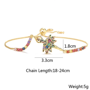 Detailed view of ballerina pendant with multicolored crystals on a gold chain