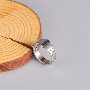 Detailed view of silver watch-band style wide ring on a wooden display stand