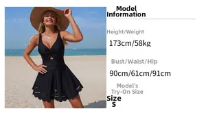 Detail of black one-piece swimsuit with V-neck ruffles and laser-cut lace hem on beach