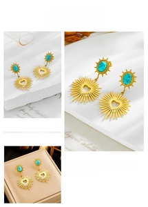 Macro view of gold sunburst heart earrings with turquoise stones and vintage textures
