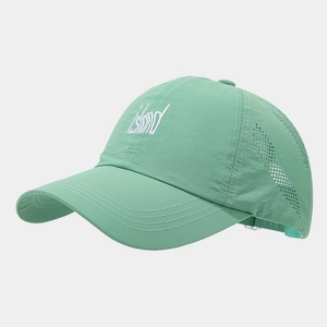 Detail of mint green breathable baseball cap with laser-cut side vents and island embroidery