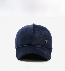 Detailed macro view of navy corduroy fabric and metallic hexagonal logo on the baseball cap