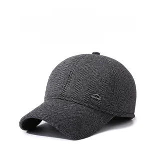 Detail of dark grey herringbone wool baseball cap with foldable ear protection flaps