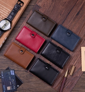 Detail showing various textures and colors of compact RFID blocking card holders with metal snaps