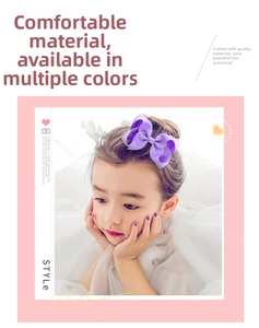 Detail of vibrant purple handmade grosgrain ribbon hair bow on a young girl hair bun