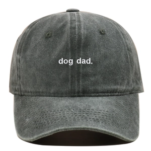 Detail of white dog dad embroidery on charcoal washed cotton baseball cap with seam texture