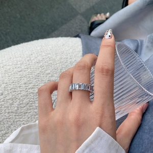 Macro view of S925 sterling silver ring with blue rectangular zircons on finger