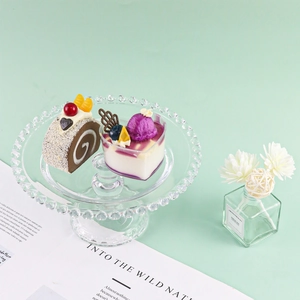 Macro detail of artificial heart mousse cake and chocolate swiss roll on glass tray