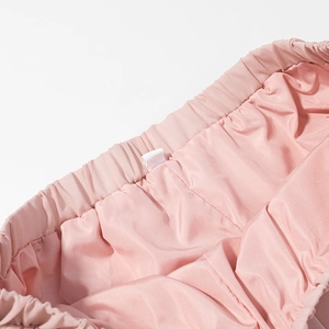 Detailed view of pink chiffon elastic waistband with soft satin lining and fine stitching