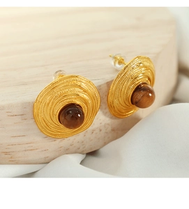 Detailed close-up of gold-plated twisted earrings inlaid with brown tiger eye stone