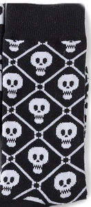Close-up of knit crew socks with white skull patterns and diamond check textures