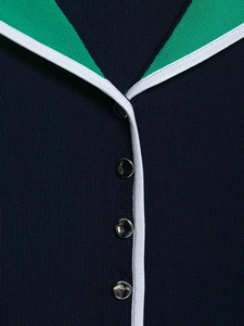 Close-up of contrast knit polo collar with green stripes and silver metal buttons