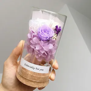 Mini glass bottle with purple preserved rose and cork base for gift decoration