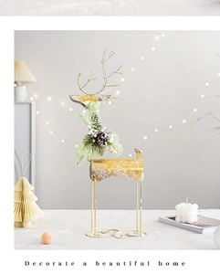 Detail of golden metal Christmas reindeer with pine needles, berries and pine cones
